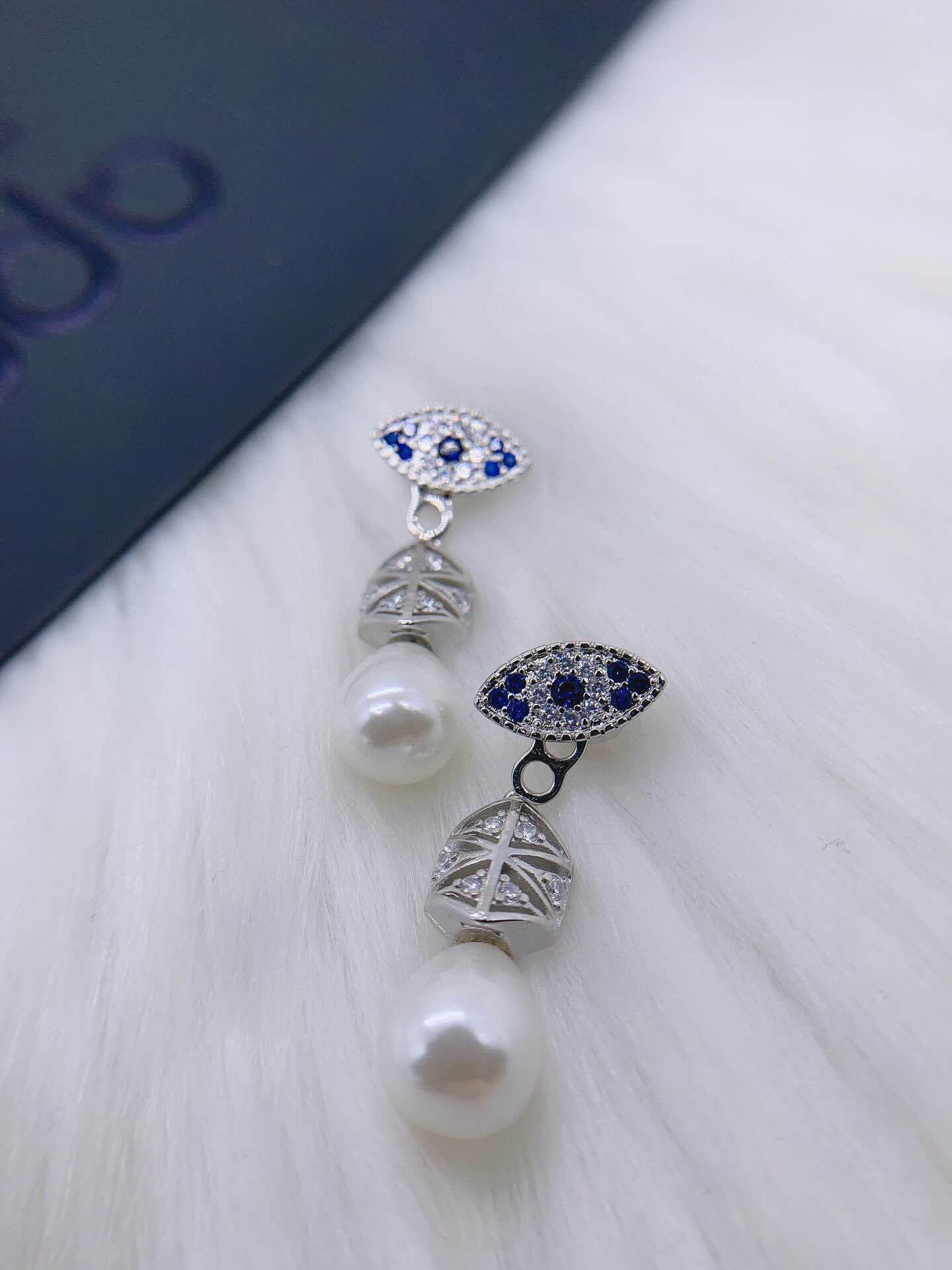 APM Monaco Elegant Pearl and Sapphire Eye Stud Earrings
